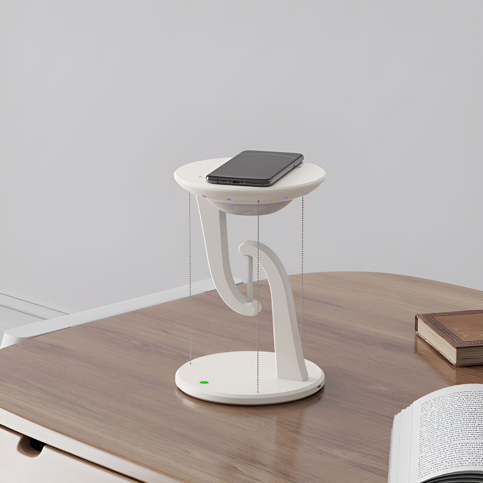 chargeur sans fil avec lampe de chevet en suspension magnétique sur une table avec un téléphone portable qui charge